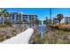 Private beach access with signage for residents only, surrounded by natural dunes at 625 Beach Rd # 207, Sarasota, FL 34242