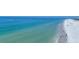 Expansive beach view showcasing the clear turquoise water and pristine sandy shoreline filled with visitors at 625 Beach Rd # 207, Sarasota, FL 34242