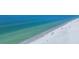 Panoramic beach view showcasing the crystal-clear turquoise water and pristine sandy shoreline with scattered beachgoers at 625 Beach Rd # 207, Sarasota, FL 34242