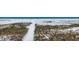 Tranquil beach access via sandy path winding through vegetation, leading to the picturesque shoreline at 625 Beach Rd # 207, Sarasota, FL 34242