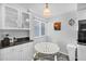 Cozy breakfast nook features a bright window and classic white furnishings at 625 Beach Rd # 207, Sarasota, FL 34242