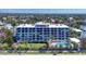 A full exterior shot of a multi-story condo building with a putting green and pool available for residents at 625 Beach Rd # 207, Sarasota, FL 34242
