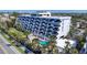 Stunning exterior of condo building features a pool, putting green, balconies, and well-maintained landscaping at 625 Beach Rd # 207, Sarasota, FL 34242