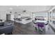 Modern kitchen with a bar area, sleek countertops, stainless steel appliances, and beautiful ocean views at 625 Beach Rd # 207, Sarasota, FL 34242