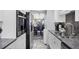 Galley kitchen features stainless appliances, sleek countertops, and a view to the dining area at 625 Beach Rd # 207, Sarasota, FL 34242