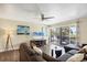 Inviting living room with comfortable sectional, hardwood floors, and sliding glass door to outside at 625 Beach Rd # 207, Sarasota, FL 34242
