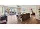 Cozy living room with hardwood floors, ceiling fan, comfortable seating, and sliding glass door access at 625 Beach Rd # 207, Sarasota, FL 34242