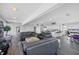 Open-concept living room featuring views, comfortable seating, and a stylish kitchen area at 625 Beach Rd # 207, Sarasota, FL 34242