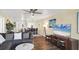 Spacious living room flows into dining area, featuring hardwood floors and an ocean view at 625 Beach Rd # 207, Sarasota, FL 34242