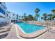 Relaxing swimming pool with comfortable lounge chairs and lush landscaping at 625 Beach Rd # 207, Sarasota, FL 34242