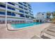 Clean swimming pool surrounded by lounge chairs offering a relaxing retreat in a tropical setting at 625 Beach Rd # 207, Sarasota, FL 34242