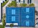 An aerial view shows two blue-toned tennis and basketball courts at 6732 Washington Pl, Bradenton, FL 34207