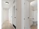Hallway featuring tile floors, storage, and access to the bathroom at 6732 Washington Pl, Bradenton, FL 34207