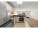 Updated kitchen featuring stainless steel appliances and granite countertops at 6732 Washington Pl, Bradenton, FL 34207