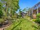 Sprawling lawn and landscaping frame a home with a screened-in lanai and a caged area at 6748 Hickory Hammock Cir, Bradenton, FL 34202