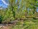 Lush landscaping and mature trees accent a well-maintained backyard, creating a private outdoor haven at 6748 Hickory Hammock Cir, Bradenton, FL 34202