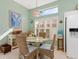 Cozy breakfast nook with wicker chairs, a glass table, and plantation shutters providing privacy at 6748 Hickory Hammock Cir, Bradenton, FL 34202