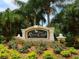 Elegant community sign for River Club set amidst vibrant landscaping of flowers and shrubs at 6748 Hickory Hammock Cir, Bradenton, FL 34202