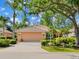 A well-maintained home featuring a two-car garage, manicured landscaping, and healthy shrubs adding to its curb appeal at 6748 Hickory Hammock Cir, Bradenton, FL 34202