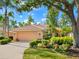 Charming single-story home with a tiled roof, a manicured lawn, and lush landscaping at 6748 Hickory Hammock Cir, Bradenton, FL 34202