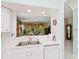 Kitchen featuring dual sinks and a view to another living space through a pass through window at 6748 Hickory Hammock Cir, Bradenton, FL 34202