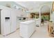 Kitchen features island, white cabinetry, lots of light and easy flow to rest of home at 6748 Hickory Hammock Cir, Bradenton, FL 34202