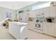 Bright kitchen featuring white cabinets, an island, and a breakfast nook with lots of natural light at 6748 Hickory Hammock Cir, Bradenton, FL 34202