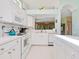 Bright kitchen with white cabinetry and plenty of counter space, great for cooking at 6748 Hickory Hammock Cir, Bradenton, FL 34202