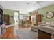 Spacious living room with wood floors, area rug and large windows providing ample natural light at 6748 Hickory Hammock Cir, Bradenton, FL 34202