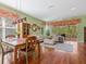 Bright living space with wood floors, neutral décor, and a sliding glass door leading to an outdoor patio at 6748 Hickory Hammock Cir, Bradenton, FL 34202