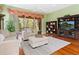 A comfortable seating area with sliding glass doors leading to an outdoor patio, complemented by a built-in entertainment center at 6748 Hickory Hammock Cir, Bradenton, FL 34202