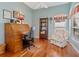 Charming office space with hardwood floors, a classic roll-top desk, and a comfortable armchair at 6748 Hickory Hammock Cir, Bradenton, FL 34202