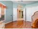 Bright office featuring hardwood floors, double doors, and ample natural light, creating an inviting workspace at 6748 Hickory Hammock Cir, Bradenton, FL 34202