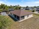 Aerial view of a cozy home with a screened-in patio and spacious yard in a quiet neighborhood at 7145 Mamouth St, Englewood, FL 34224