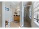 Modern bathroom featuring a glass-enclosed shower, vanity with sink, and a neutral color scheme at 7145 Mamouth St, Englewood, FL 34224