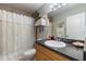 Cozy bathroom featuring a shower with a seashell-themed curtain and a single sink vanity at 7145 Mamouth St, Englewood, FL 34224