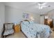 Bedroom with light walls, tile floors, and a charming chair and dresser at 7145 Mamouth St, Englewood, FL 34224