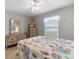 Bright bedroom with dresser, side tables, and a comfortable bed under a ceiling fan at 7145 Mamouth St, Englewood, FL 34224