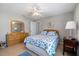 Bright bedroom with a ceiling fan, neutral wall colors, tile floors, and furnishings at 7145 Mamouth St, Englewood, FL 34224