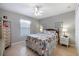 Well-lit bedroom with a ceiling fan, tile floor, and comfortable furnishings at 7145 Mamouth St, Englewood, FL 34224