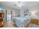 Comfortable bedroom boasts a ceiling fan and sliding glass doors leading to an outdoor area at 7145 Mamouth St, Englewood, FL 34224
