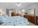 Spacious bedroom featuring a decorative mirror and a colorful quilt on the bed at 7145 Mamouth St, Englewood, FL 34224