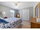 Bright bedroom with a ceiling fan, white trim, neutral wall colors, and tile floors at 7145 Mamouth St, Englewood, FL 34224