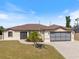 Charming single-story home with a well-manicured lawn and a two-car garage, perfect for comfortable living at 7145 Mamouth St, Englewood, FL 34224