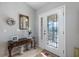 Elegant foyer featuring a decorative mirror and a beautifully designed front door with sidelights at 7145 Mamouth St, Englewood, FL 34224