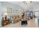 Cozy living room featuring a reclining sofa, coastal decor, and tiled floors under a vaulted ceiling at 7145 Mamouth St, Englewood, FL 34224