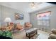 Comfortable sitting room with natural light, tiled floors, and a decorative window treatment at 7145 Mamouth St, Englewood, FL 34224