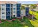 Aerial view of a condo complex with screened patios and green space at 7705 Grand Estuary Trl # 202, Bradenton, FL 34212