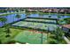 Aerial view featuring community tennis courts, basketball court, and beautifully landscaped grounds, perfect for recreation at 7705 Grand Estuary Trl # 202, Bradenton, FL 34212