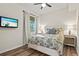 Cozy bedroom featuring a TV, ceiling fan, and matching bedside tables at 7705 Grand Estuary Trl # 202, Bradenton, FL 34212